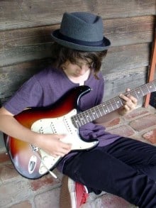 Jaron Natoly playing on the guitar