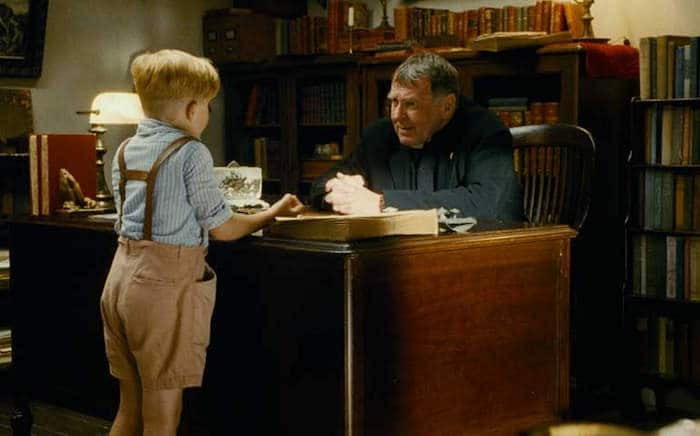 The Little Boy receiving the list from Fr. Oliver (Tom Wilkinson)