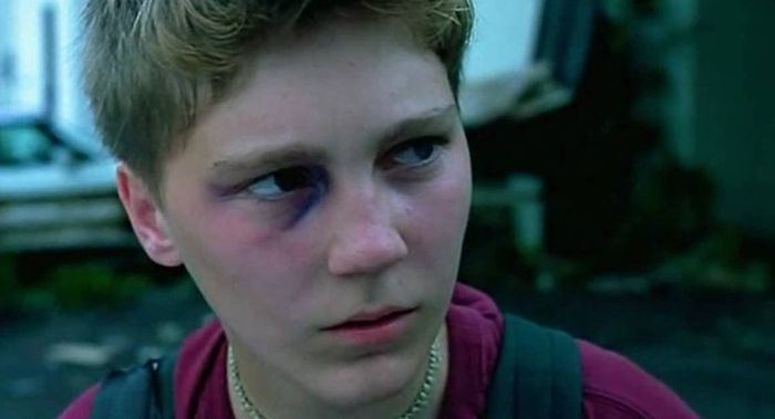 This still from L.I.E. (2001) captures Paul Dano's character, Howie Blitzer, with a solemn expression and a black eye, reflecting his vulnerability and the harsh realities of his troubled world.