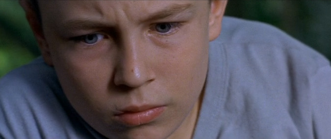 Vincent Rottiers as Joseph in The Devils (2002), his face etched with a haunting mix of vulnerability and quiet intensity, eyes clouded with turmoil and lips trembling on the edge of despair.