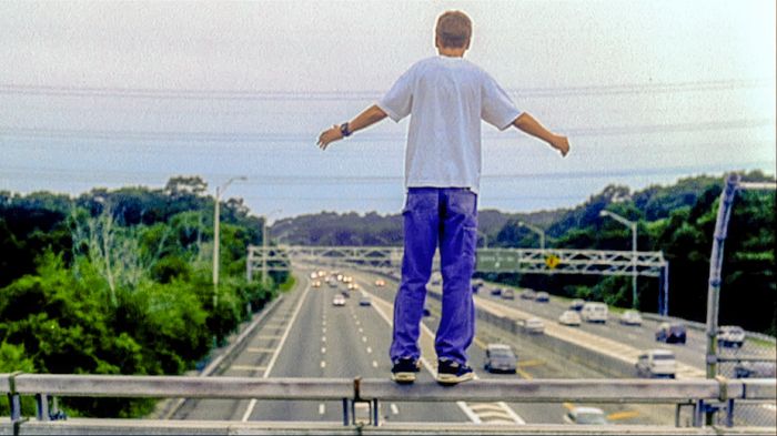 Paul Dano’s Howie Blitzer balances on a highway overpass in L.I.E. (2001), symbolizing his recklessness and search for control.