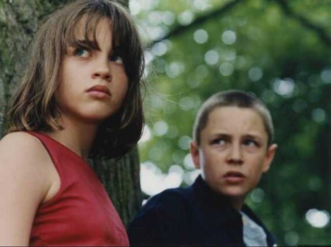 Vincent Rottiers as Joseph and Adèle Haenel as Chloé in The Devils (2002), captured in a tense, wooded moment that hints at the film’s raw, emotional intensity.