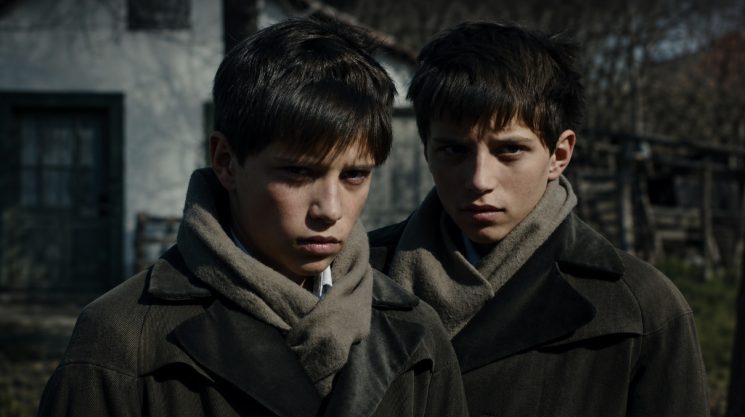 The twins’ hardened gaze captures the emotional vacuum at the heart of The Notebook.