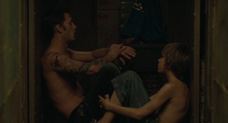 Sitting together in the dimly lit hull of the barge, Julien (Nicolas Duvauchelle) and his younger brother Louis (Steve Le Roi) share a quiet, unguarded moment away from the chaos of their heist.