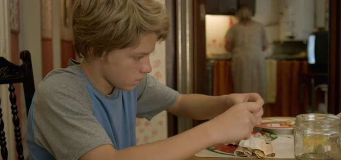 Felipe Szumik as Felipe in a quiet, introspective moment at the kitchen table in the 2023 Argentine Coming-of-Age drama Felipe.